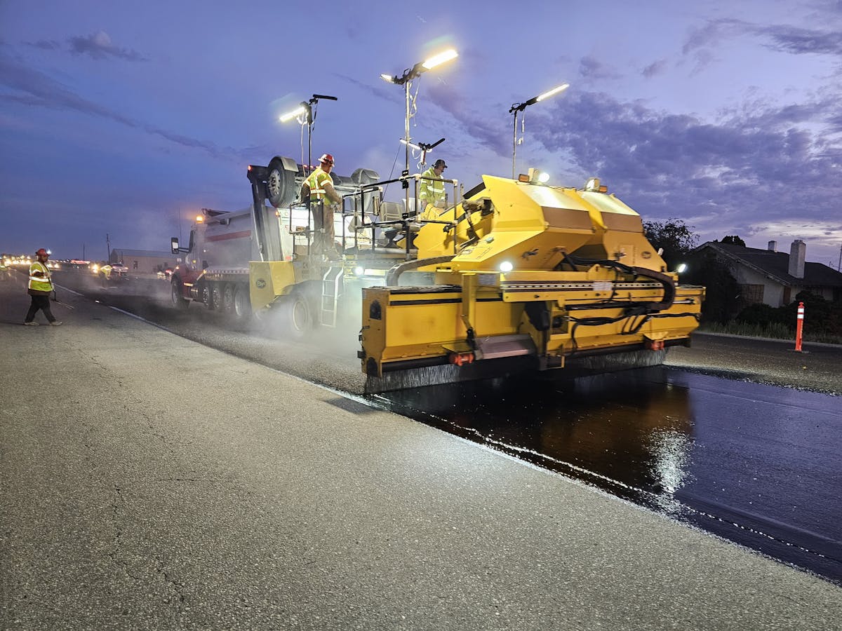 Road construction site with heavy machinery during a paving project